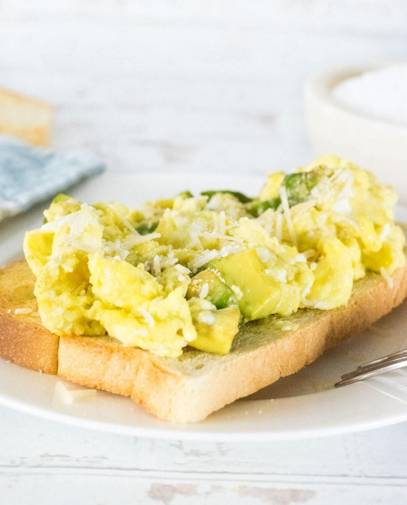 Avocado scrambled eggs topped with Parmesan cheese.