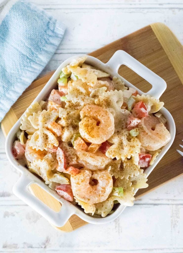 Shrimp pasta salad dusted with Cajun seasoning and viewed from above.