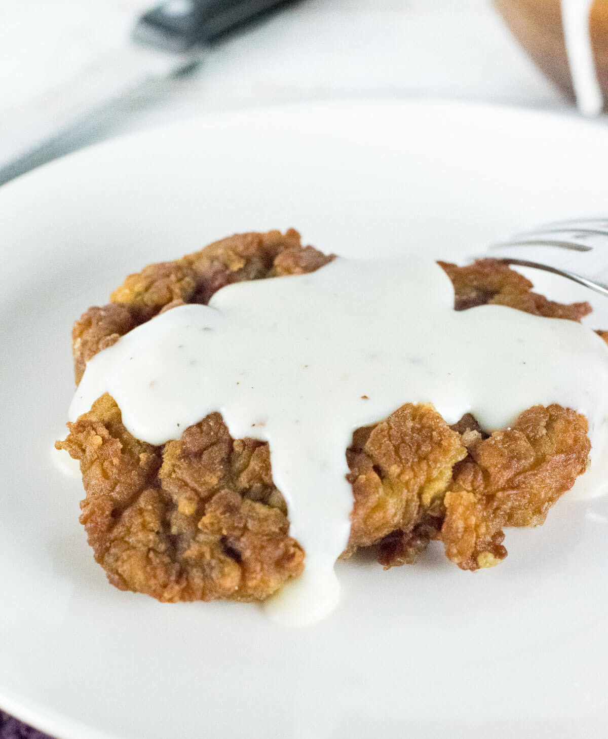 Close up of gravy covering fried venison.