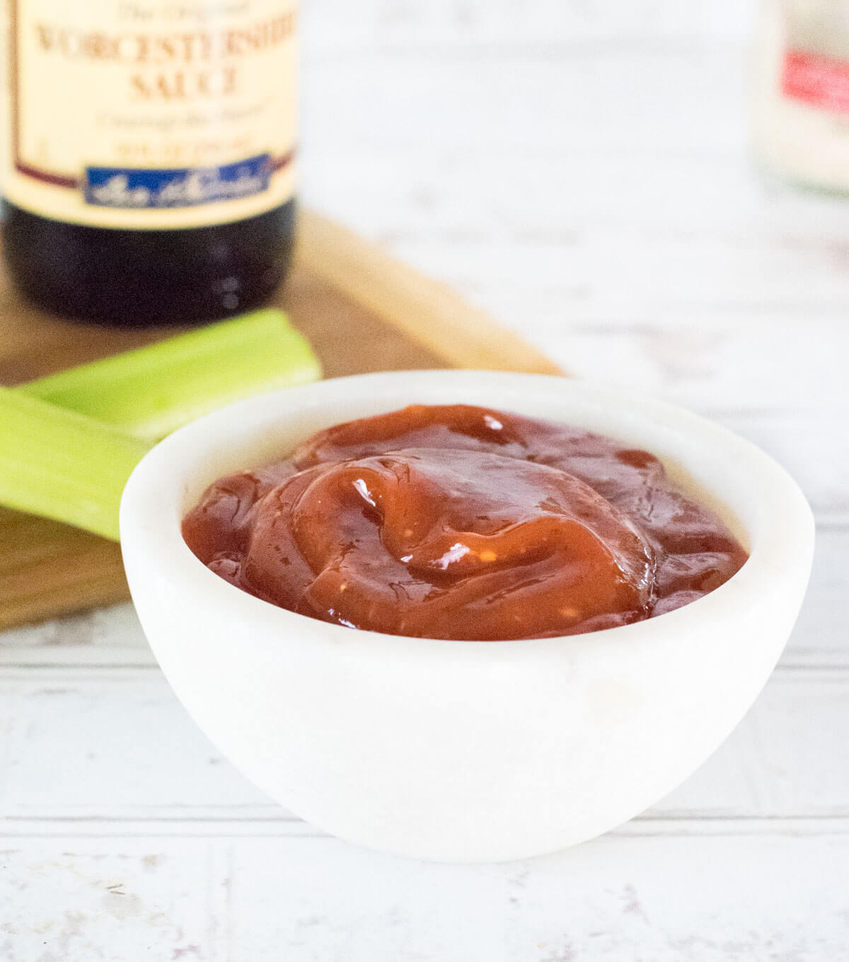 Bloody Mary Ketchup in white bowl with celery shown.