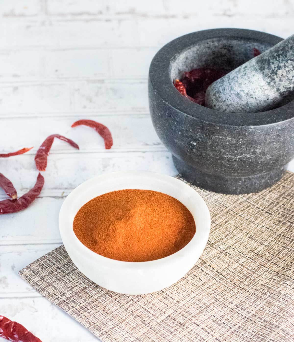 Fresh ground paprika in white bowl.