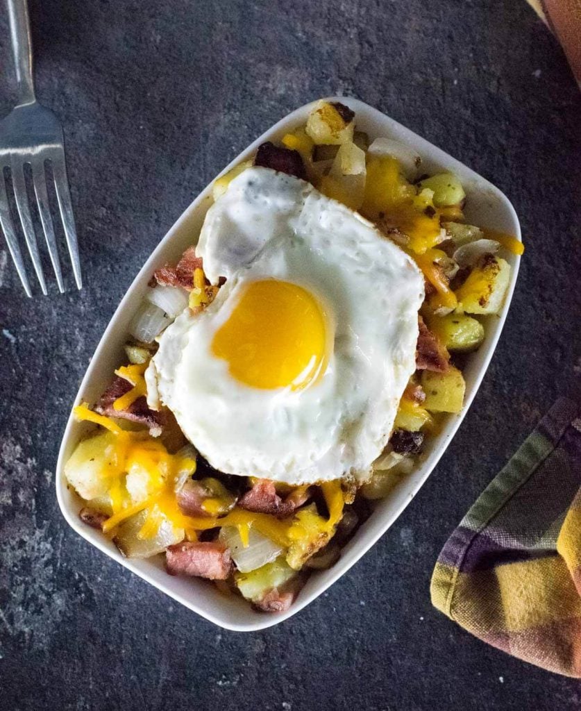 Ham and potato hash viewed from above with a fork alongside.