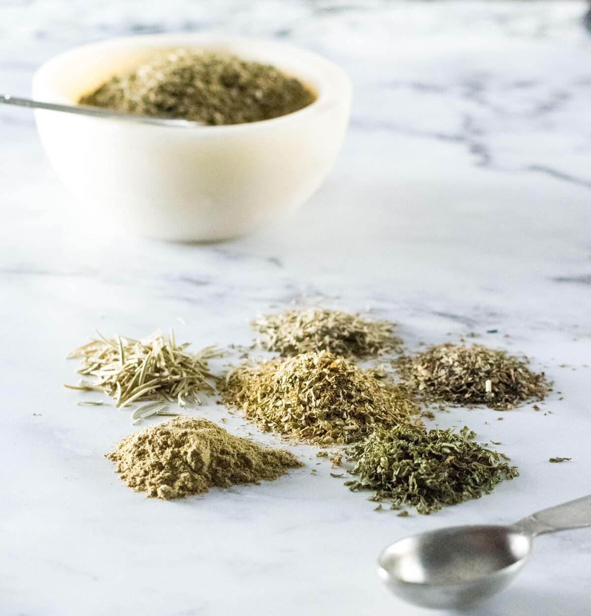 Italian seasoning separated into piles by each herb.