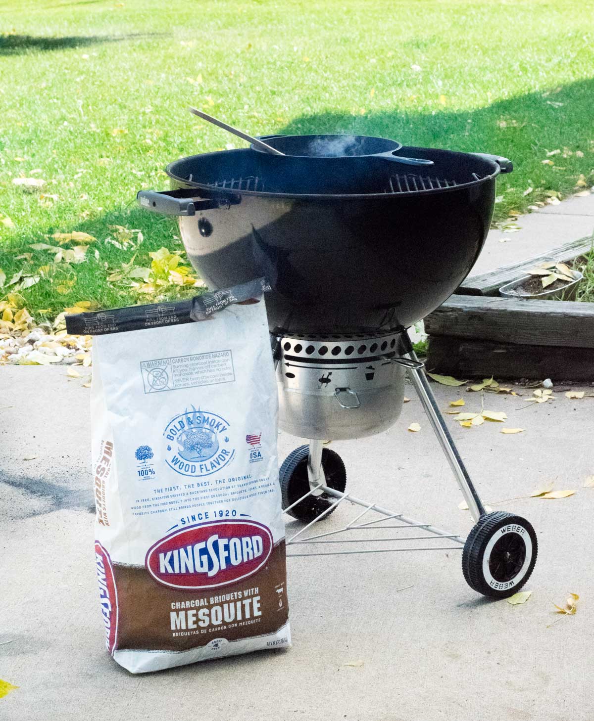 Kingsford Mesquite sitting by charcoal grill.