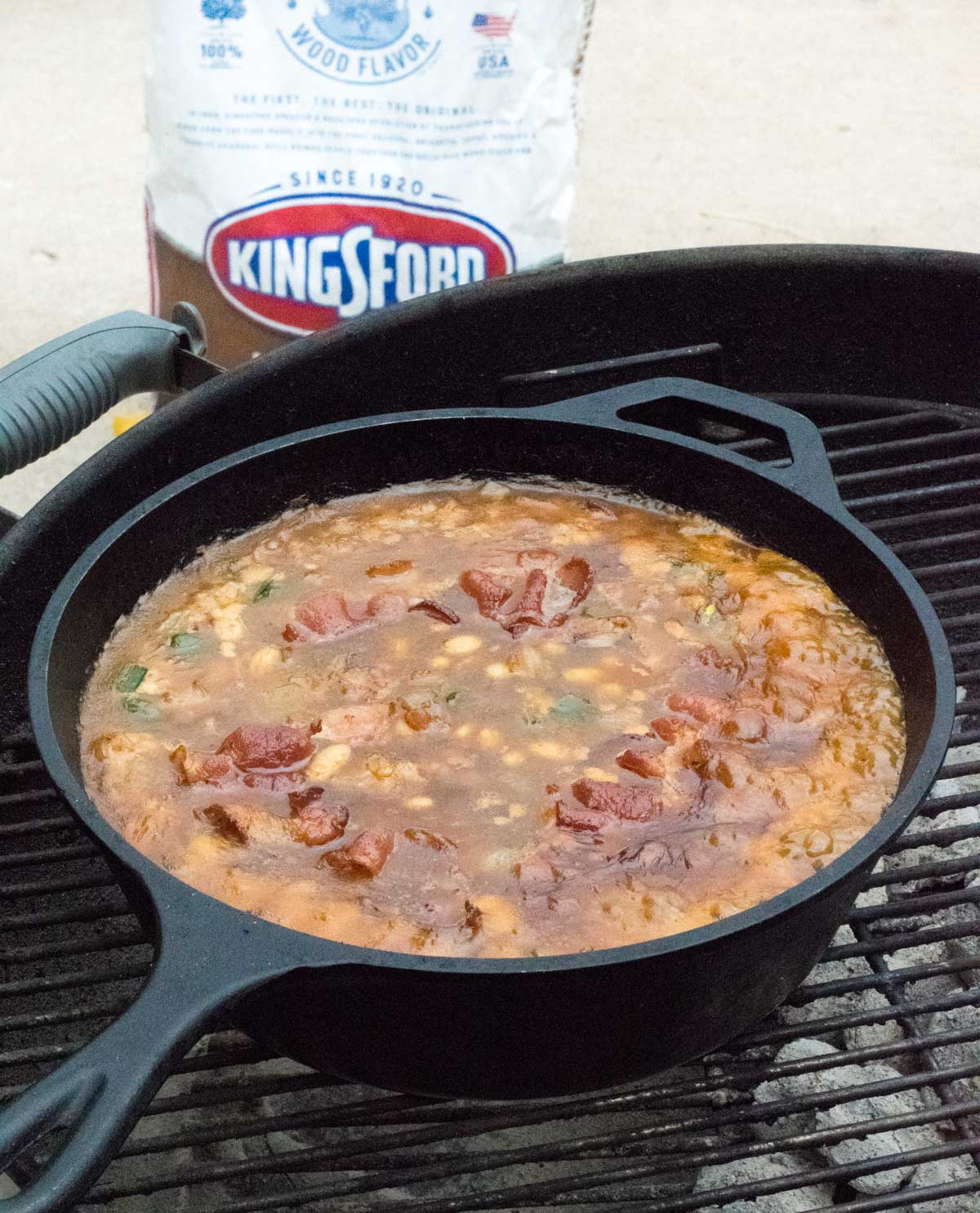 Pan on grill simmering beans.