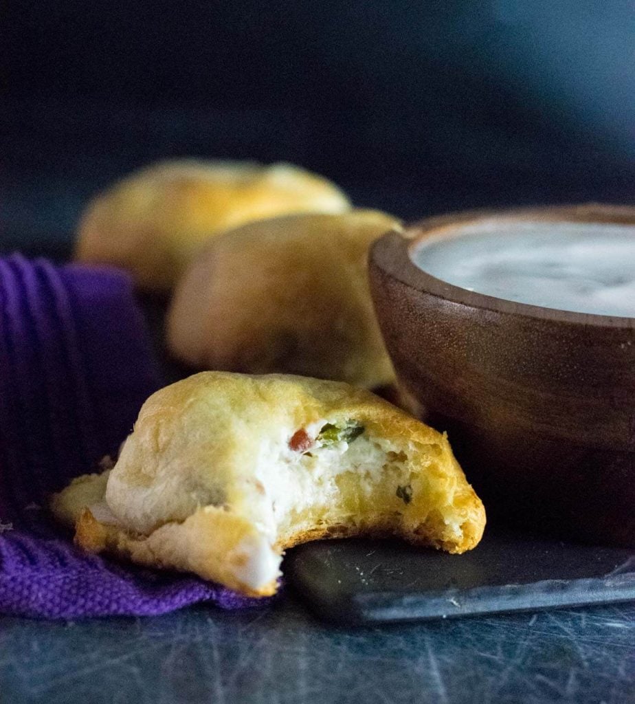 Jalapeno Popper Bites with ranch dressing sitting by purple towel.