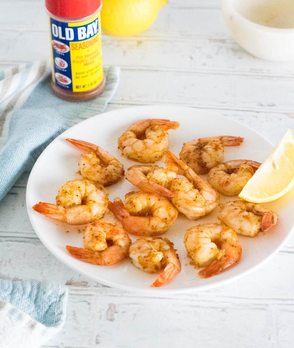 Old Bay Shrimp with seasoning bottle behind.