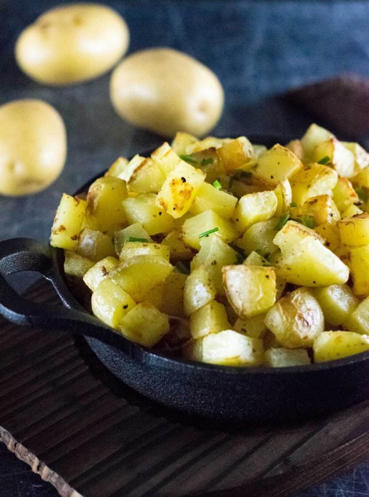 Roasted breakfast potatoes in pan, close up