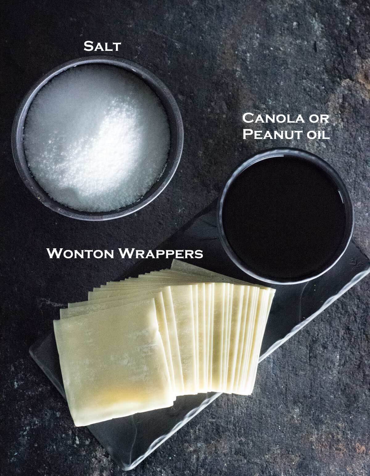 Wonton wrappers, frying oil, and salt in separate dishes.