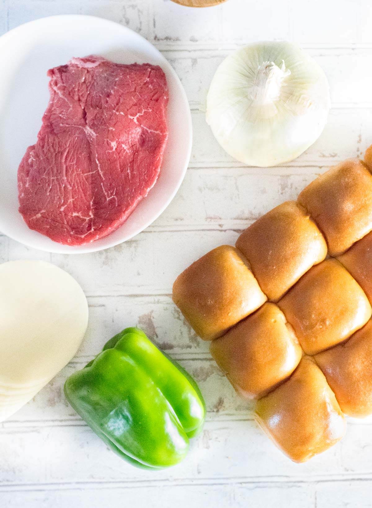 Ingredients shown are sirloin, onion, Provolone, pepper, and buns.