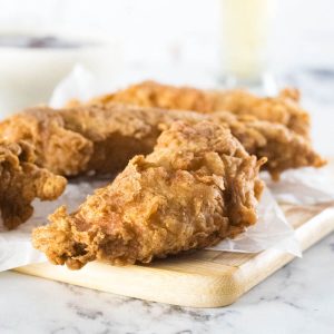 Beer battered chicken tenders shown close up.
