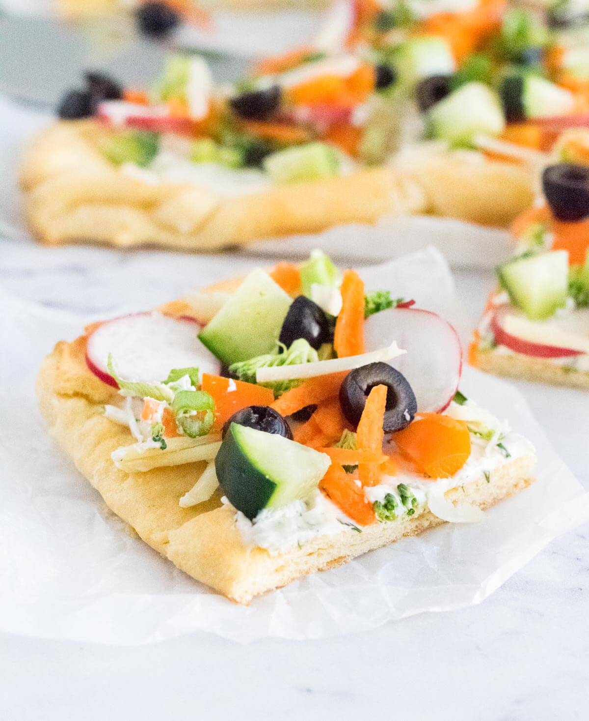 Crescent roll veggie pizza slice.