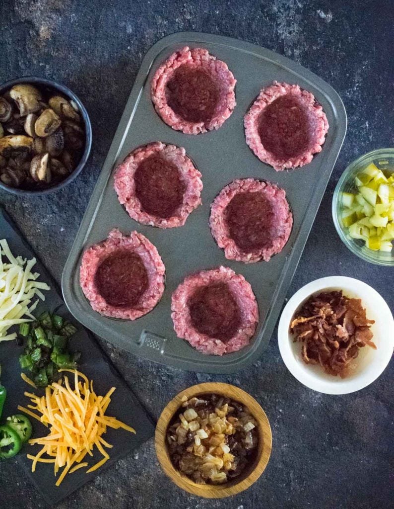 Forming burger bowls with toppings in bowls.