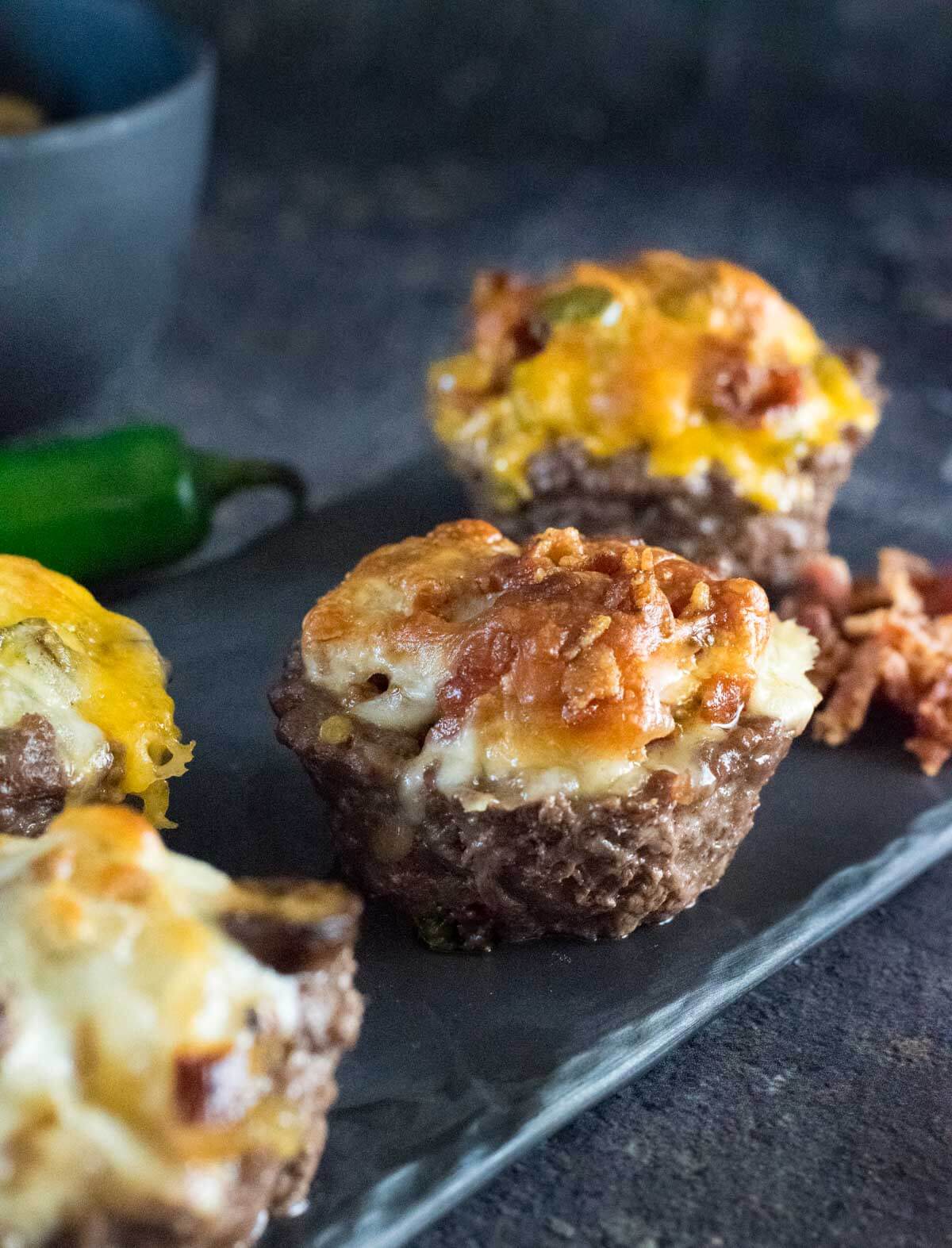 Burger bowls on a black tray.
