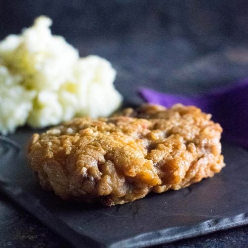 Fried venison cutlet shown close up.