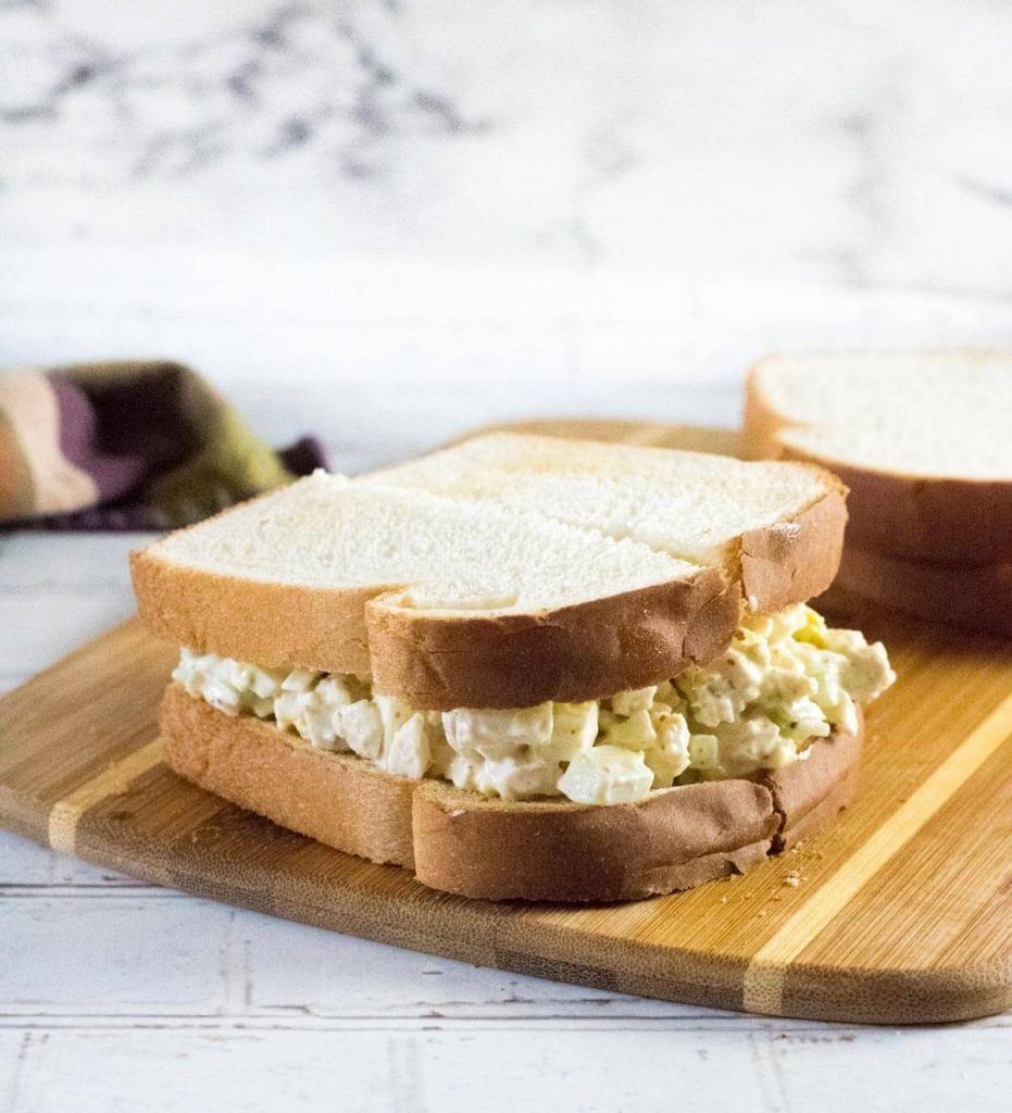 Chicken sandwich spread on white bread.