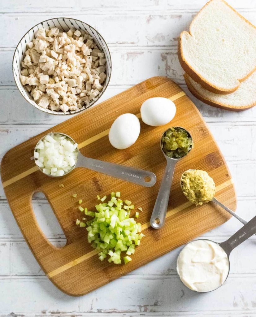 Chicken sandwich spread ingredients on cutting board.