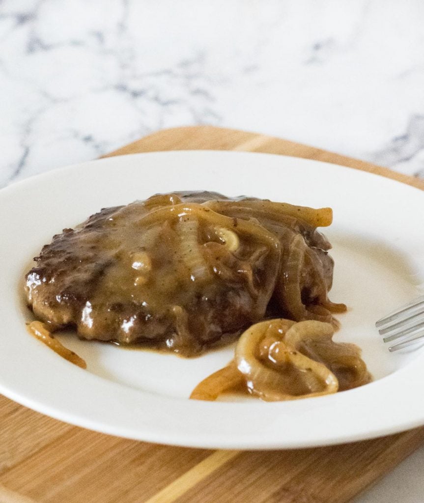 Classic Salisbury steak on white plate.