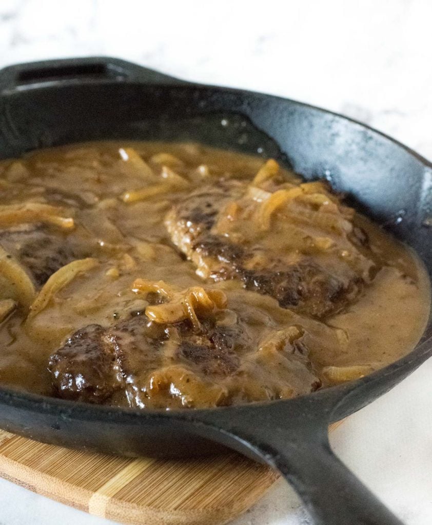 Salisbury steak in cast iron skillet.