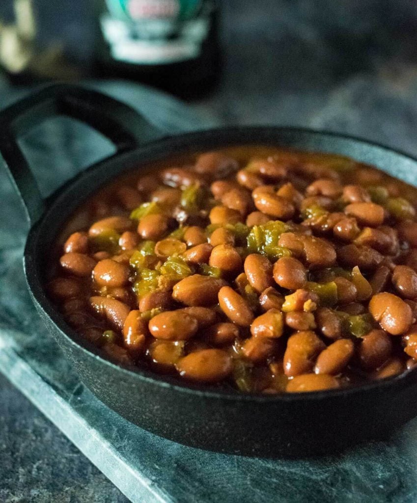 Close up view of smoked baked beans with bacon.