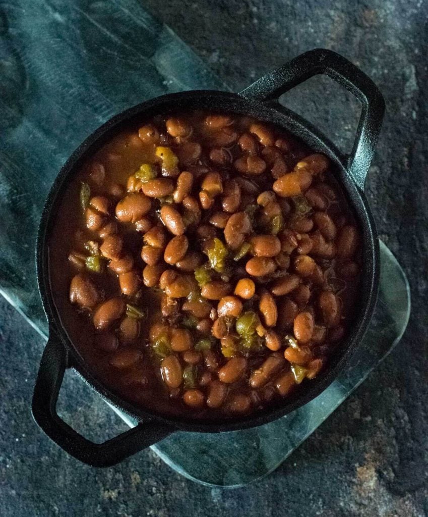 Smoked baked beans in cast iron pan.