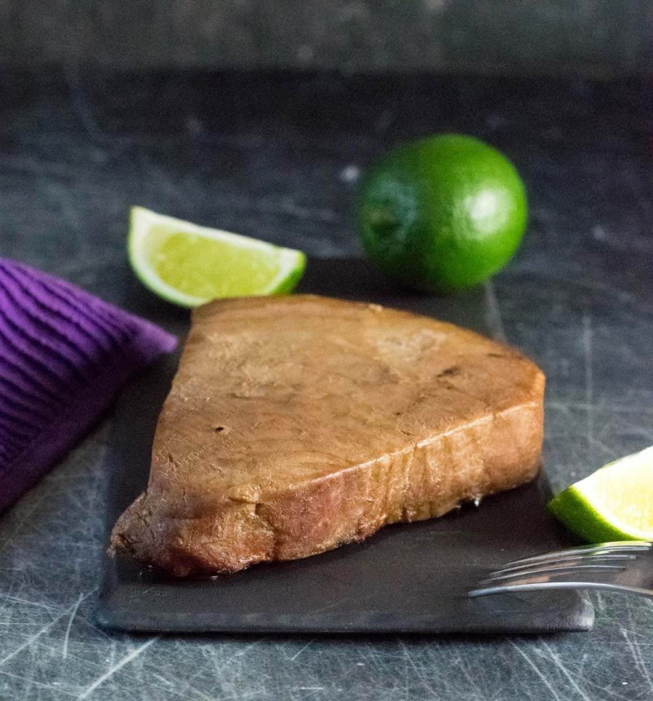 Smoked tuna steak on platter.