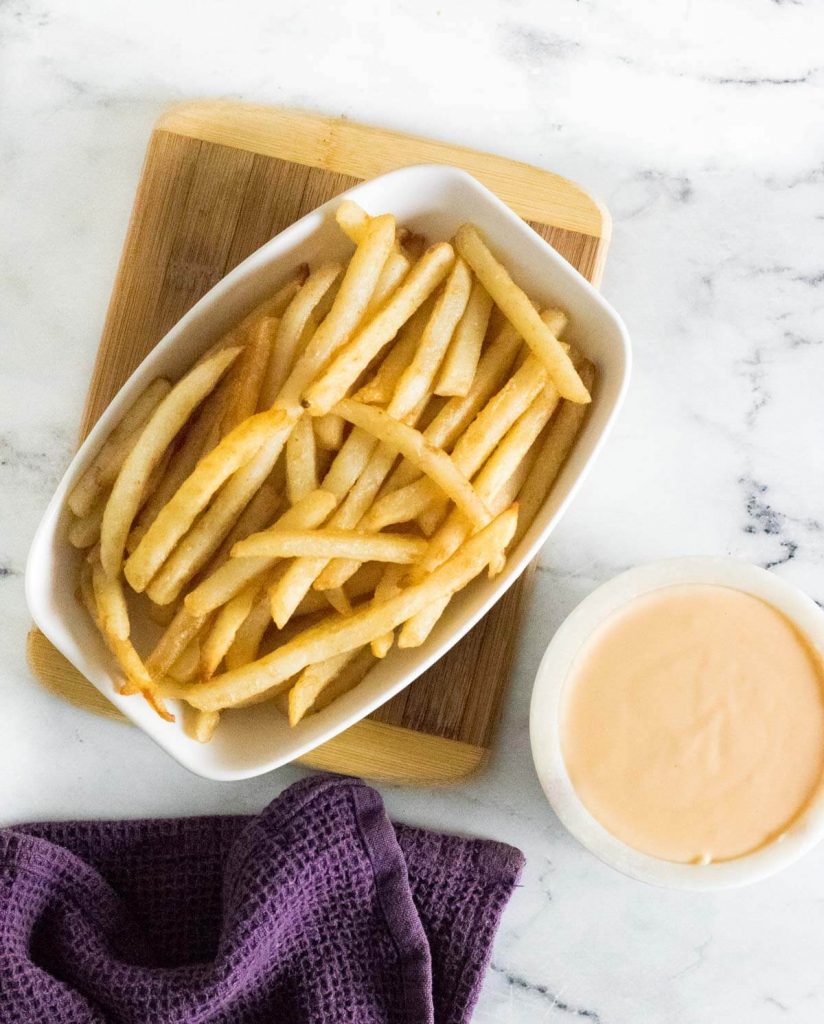 French Fries with cheese sauce for dipping in separate bowl.