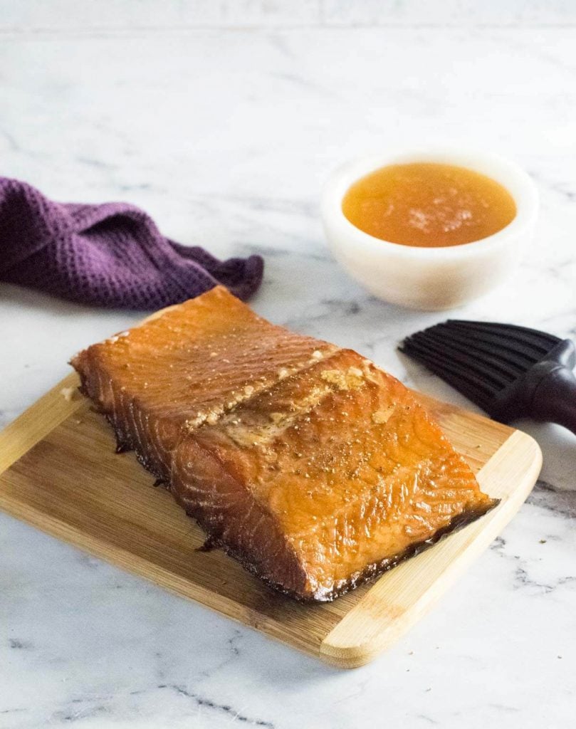 Smoked salmon with a bowl of honey.