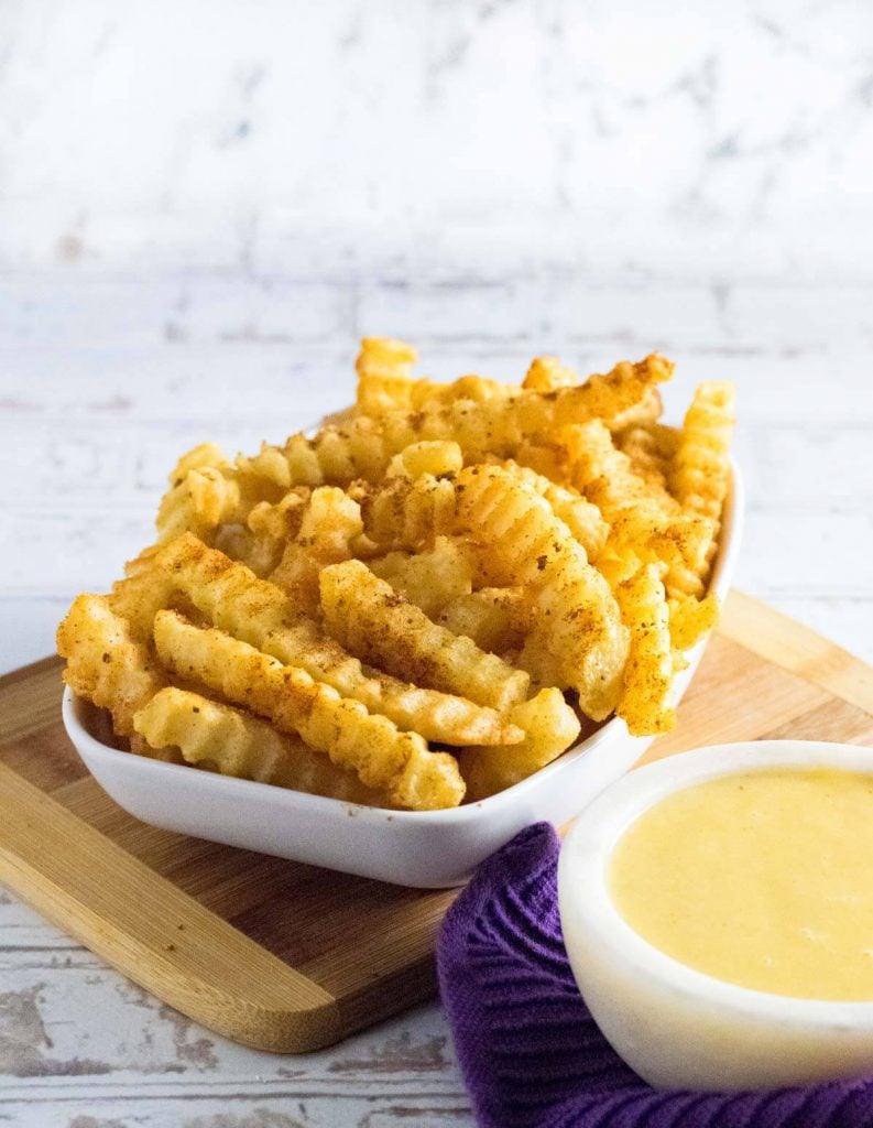 Crinkle cut fries with old bay seasoning and cheese sauce.