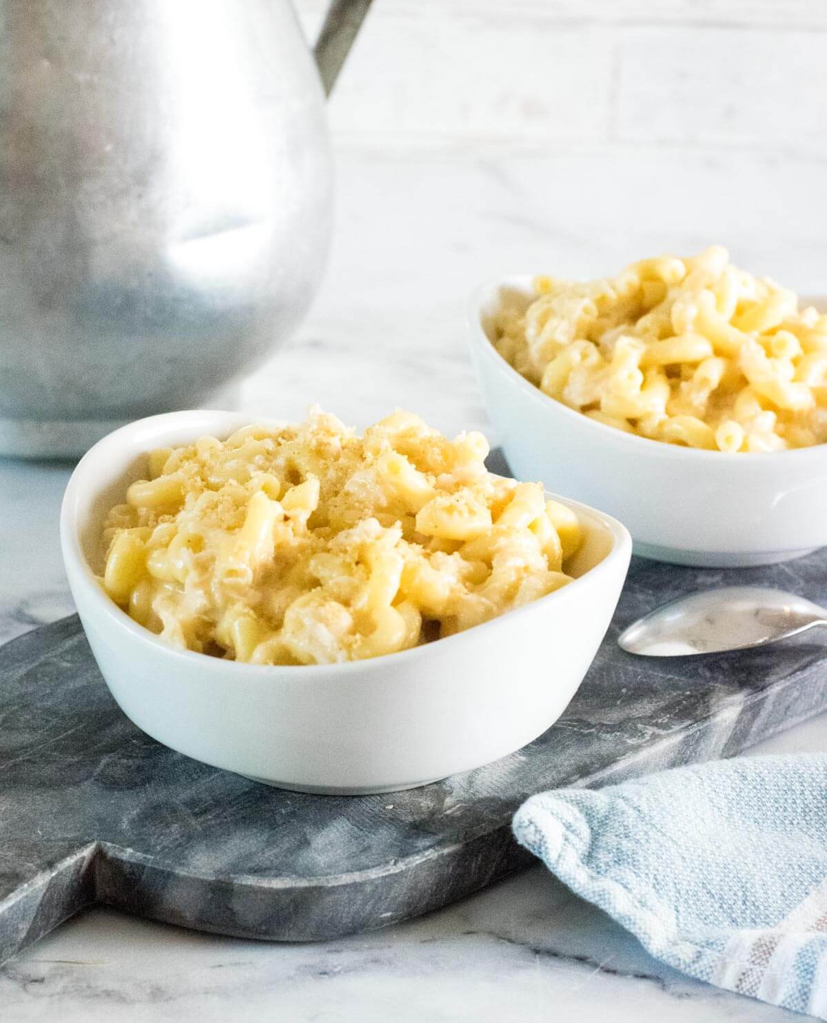Seafood mac and cheese in white bowls.