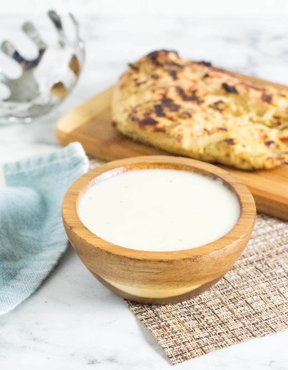 Homemade alfredo sauce in a brown bowl.