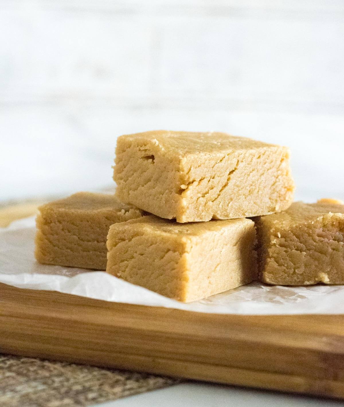 Pieces of peanut butter fudge stacked on top of each other.