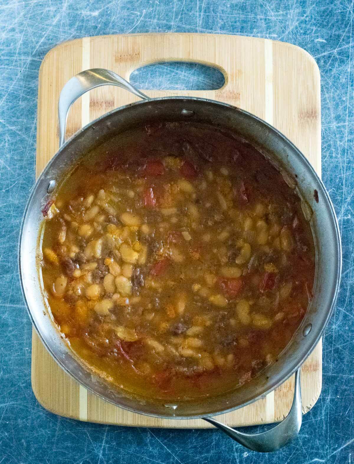 Pot of baked beans taken out of the oven.