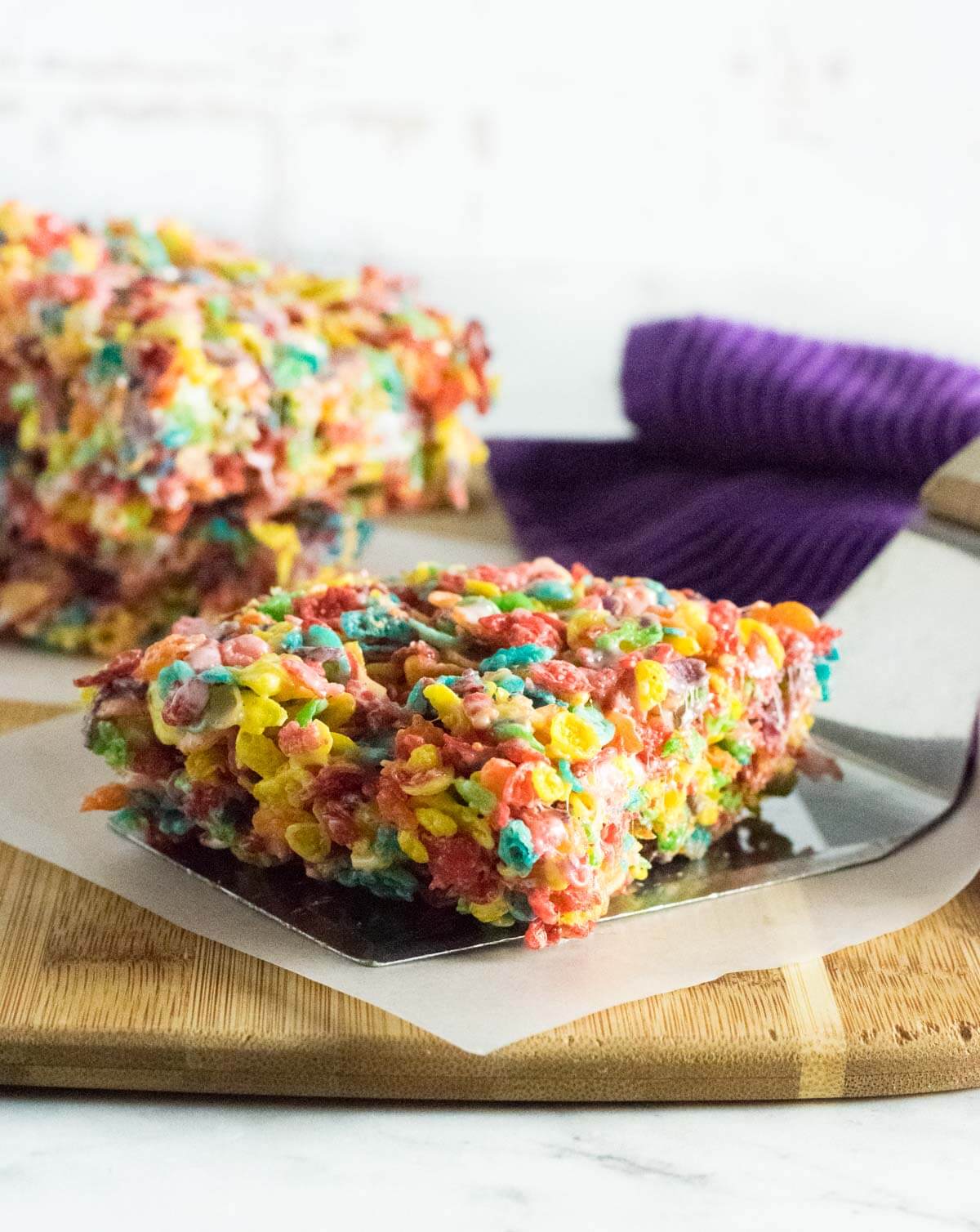 Fruity Pebbles Treats on cutting board.