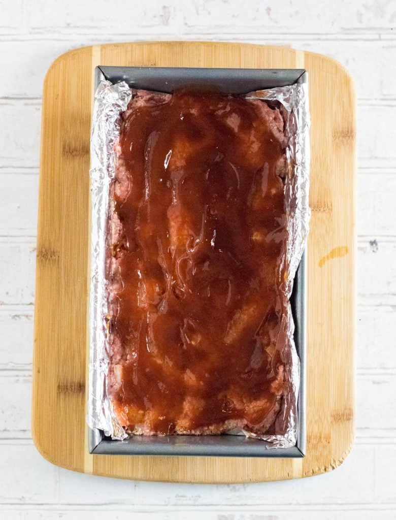 Raw meatloaf mixture in a bread pan.