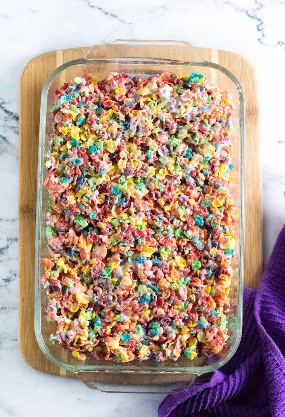 Pressing the cereal treats in a baking dish.
