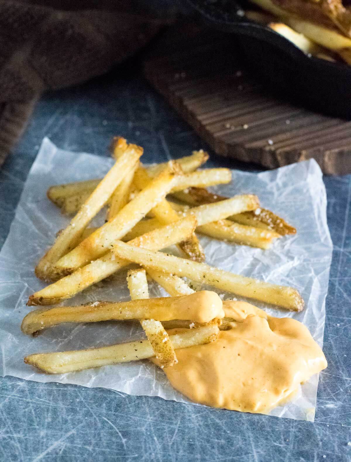 Fried truffle french fries with dipping sauce.