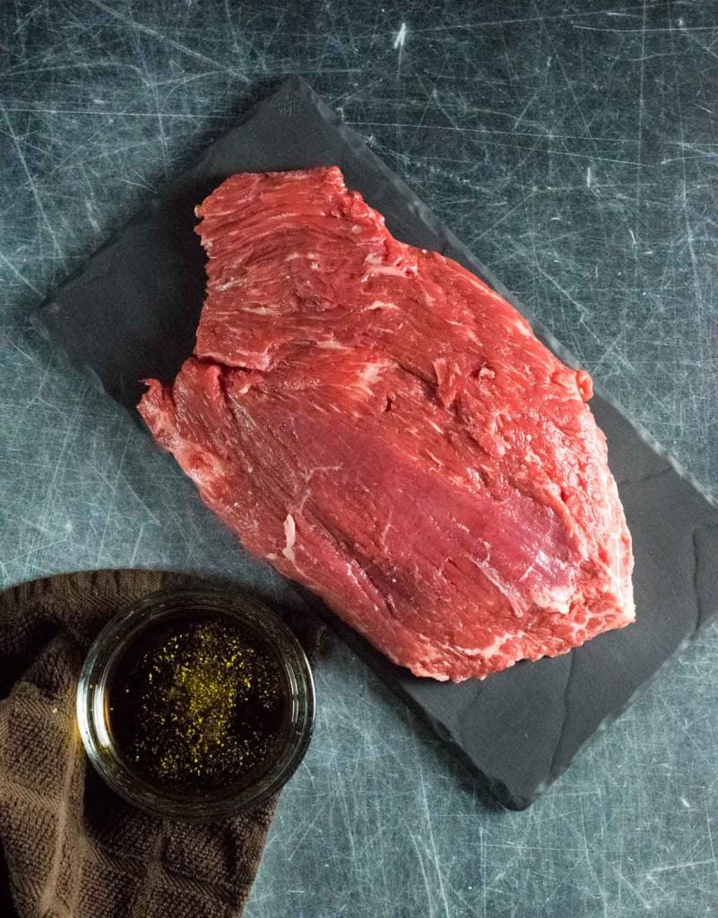Raw flank steak with marinade.