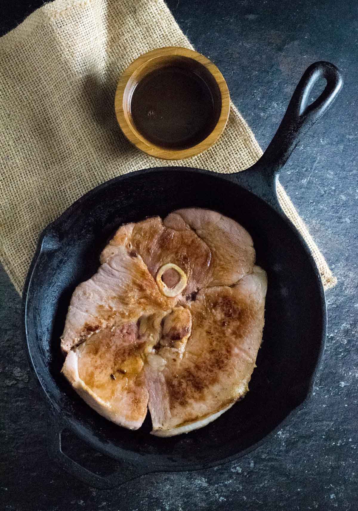 Seared country ham in skillet.