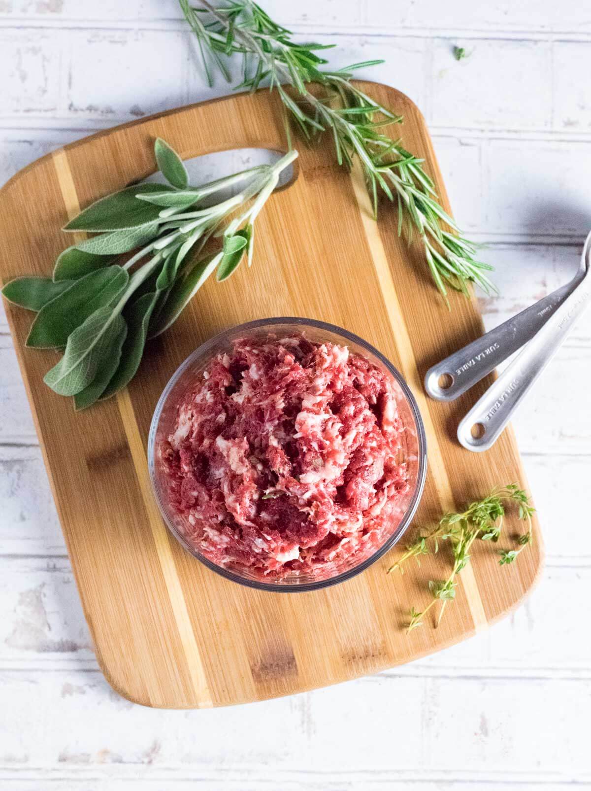 Mixing ground venison with ingredients.