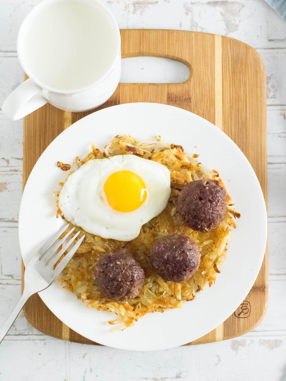 Breakfast meatballs served with egg and hashbrowns.