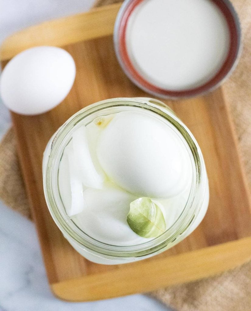 Old fashioned pickled eggs in a mason jar.