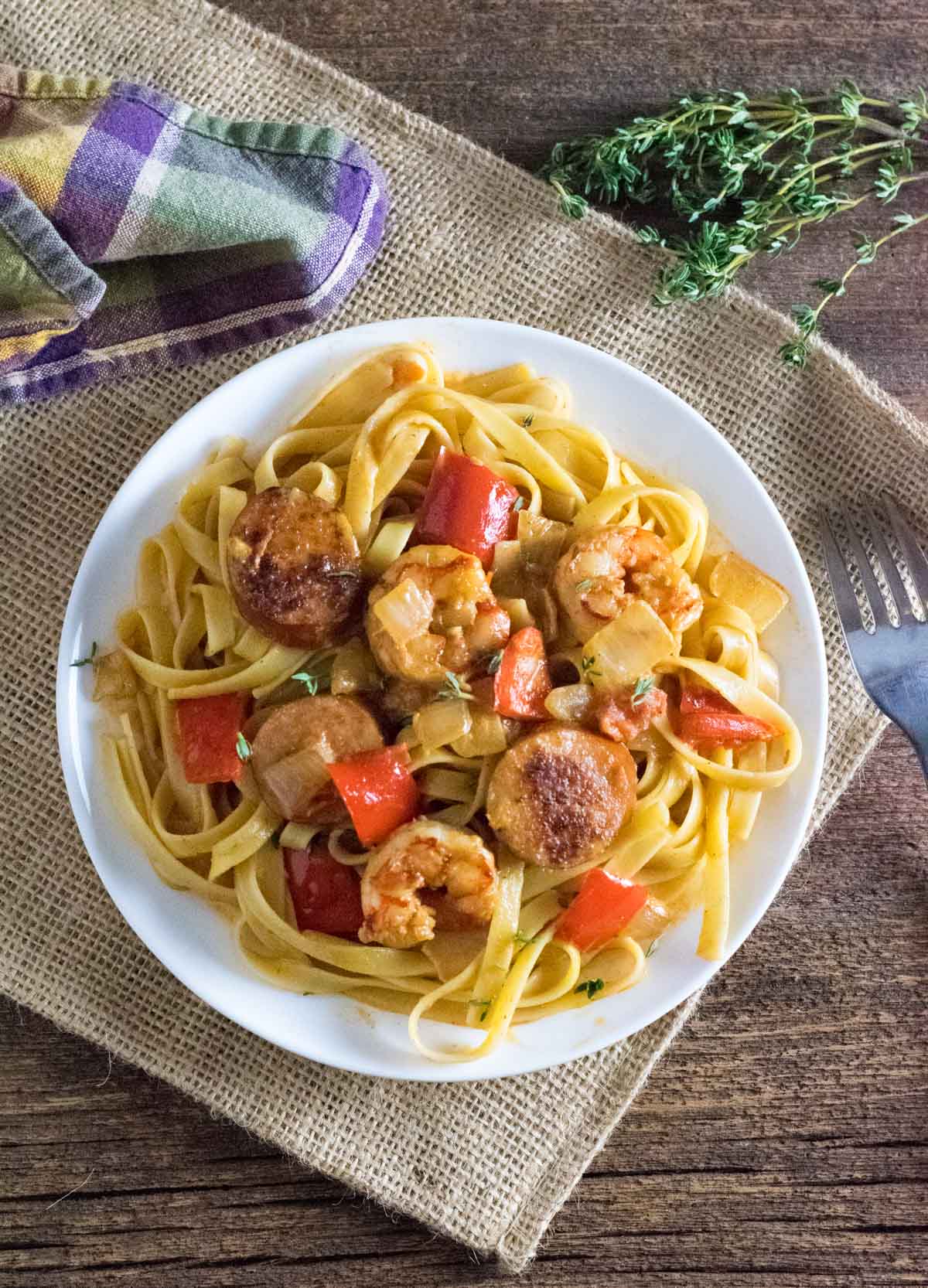 Cajun shrimp and sausage pasta on plate.