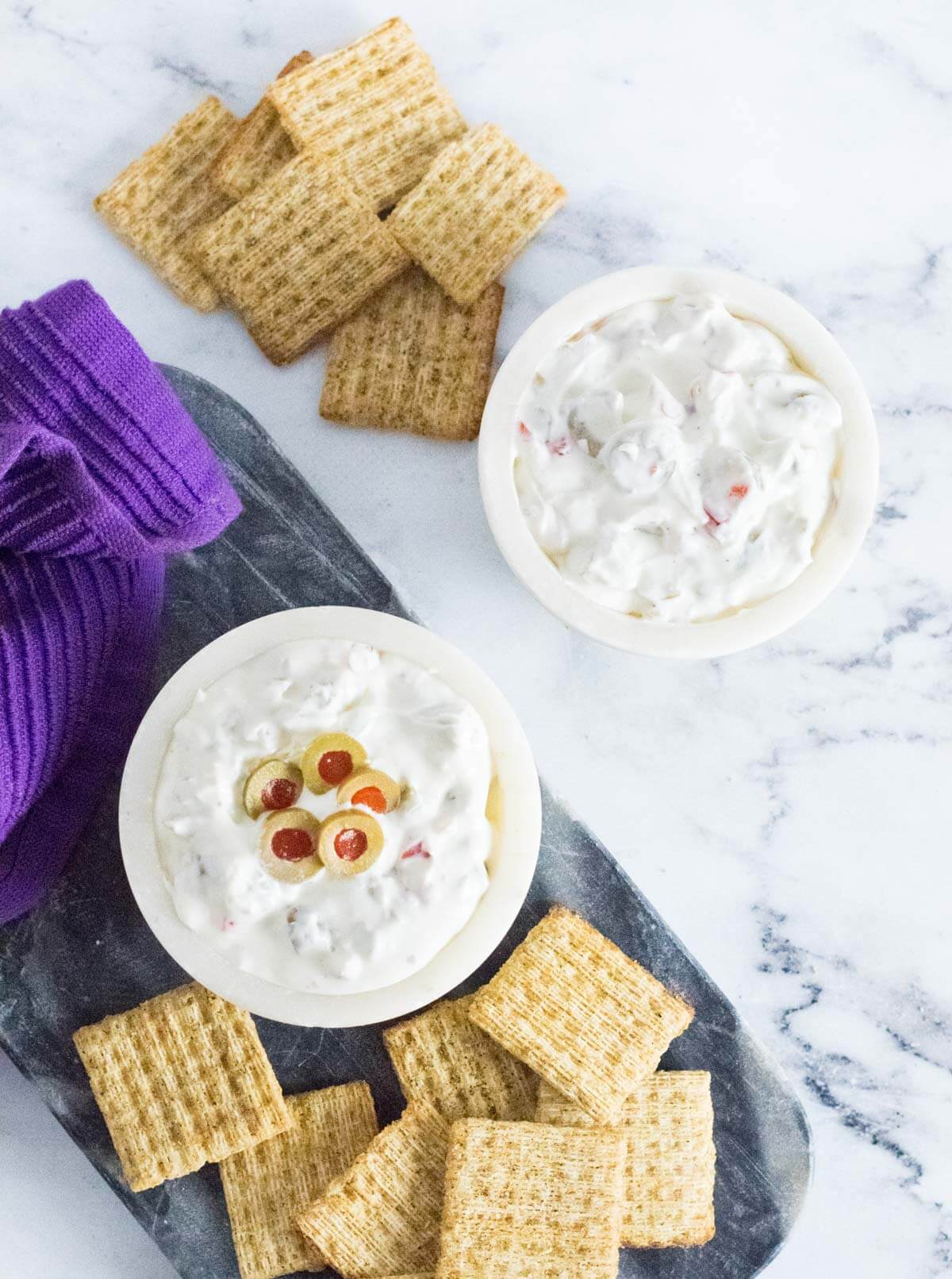 Green olive dip with crackers.