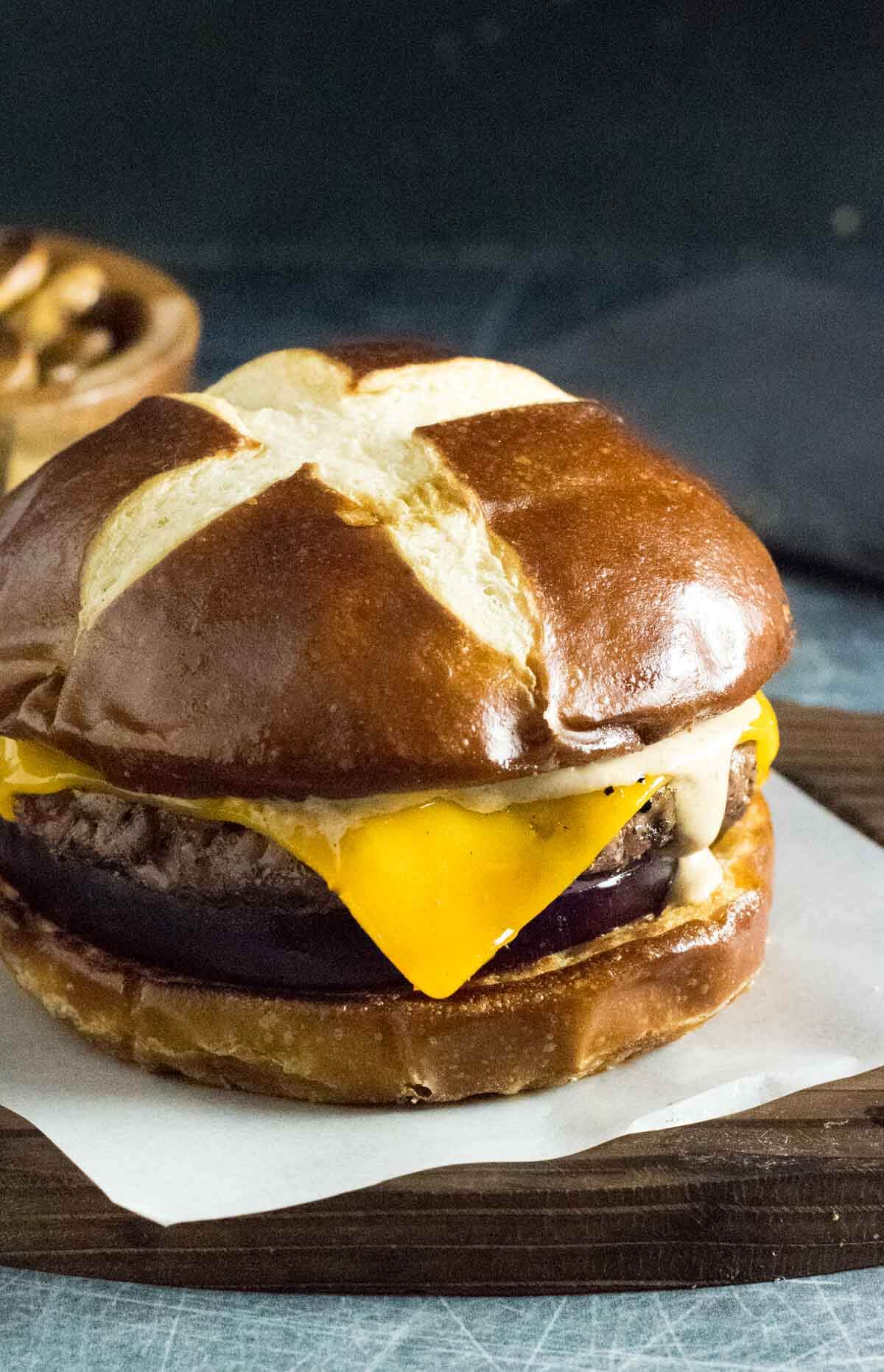 Smoked burger on pretzel bun.