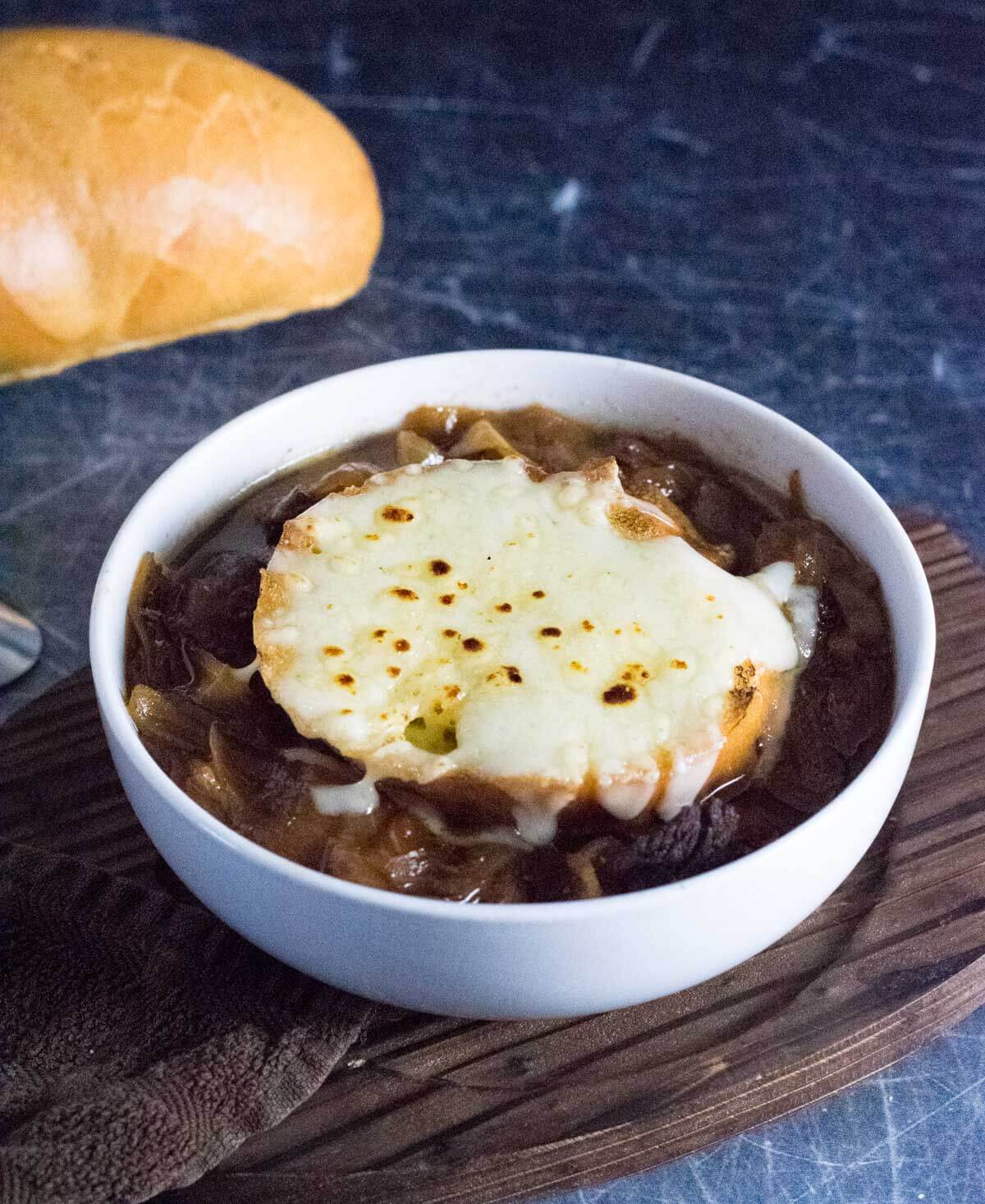 Beef French onion soup in ovenproof bowl.