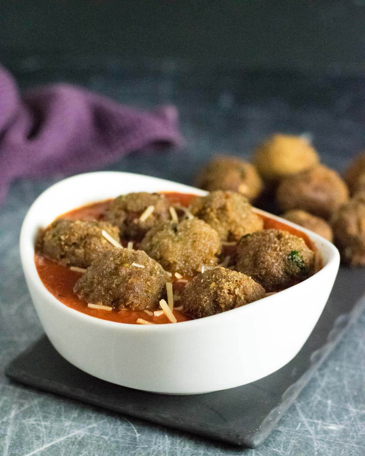 Deep fried meatballs in sauce.