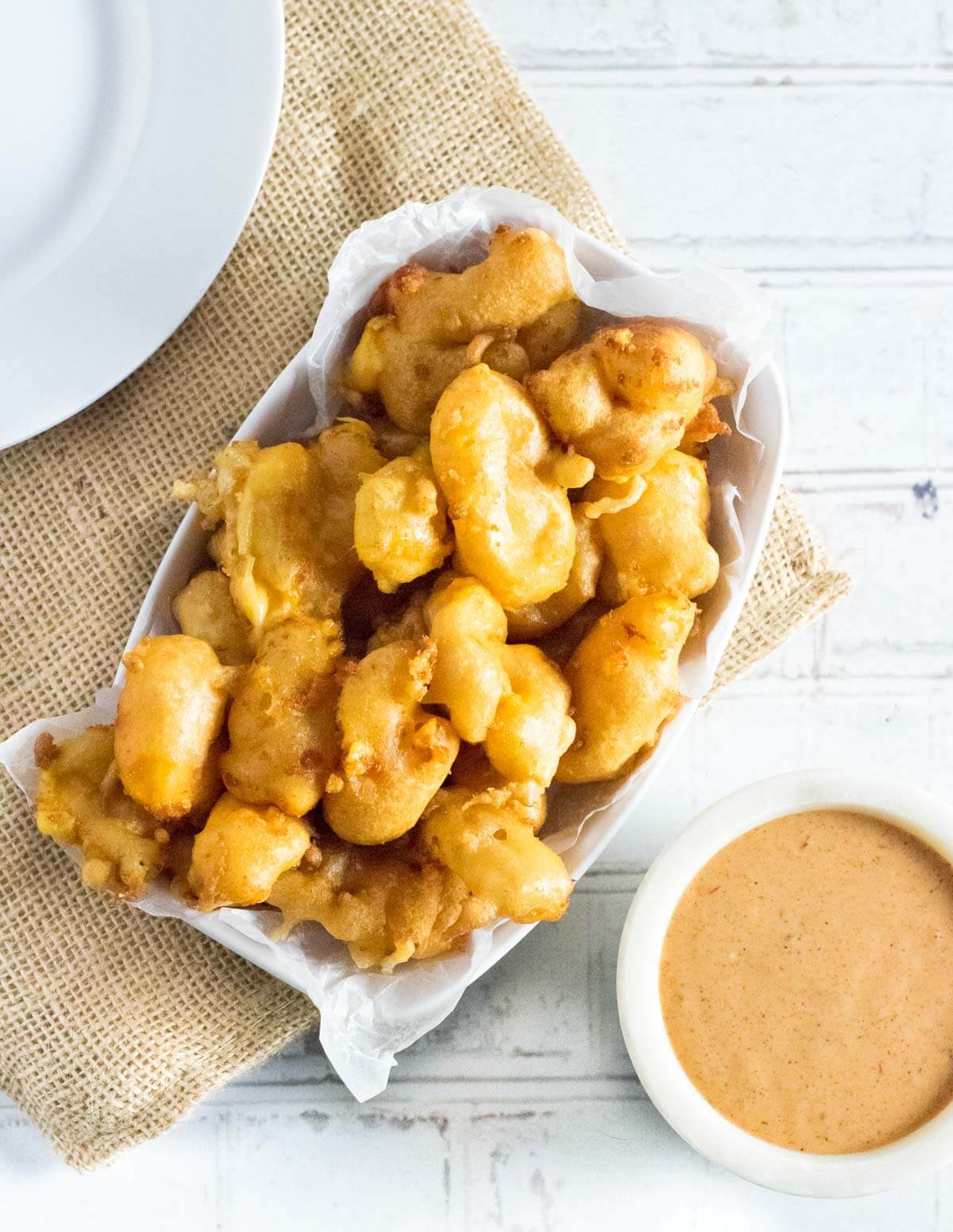 Fried cheese curds with dipping sauce.