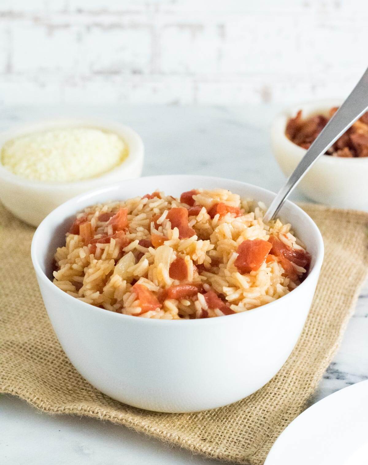 Tomatoes and rice in white bowl.