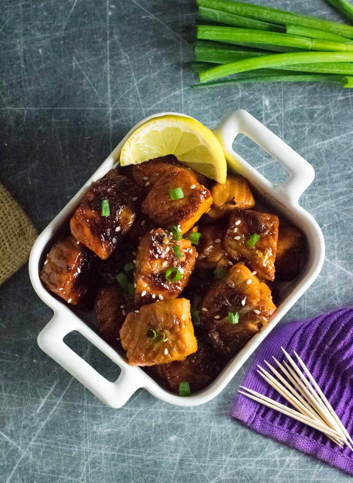 Salmon bites in white dish.